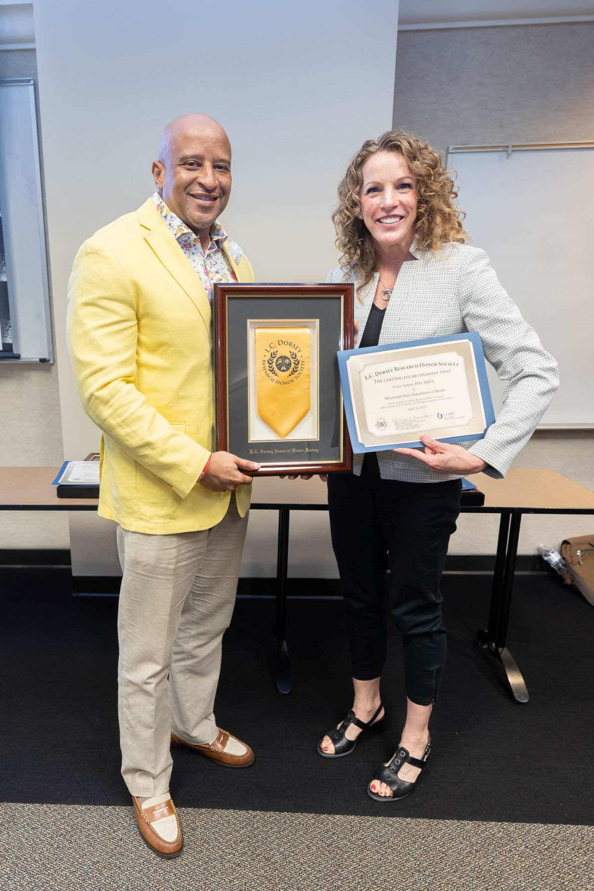 New faculty inductee into the L.C. Dorsey Honors Society standing with Dr. Reneker at the 2023 SOPH Research Day